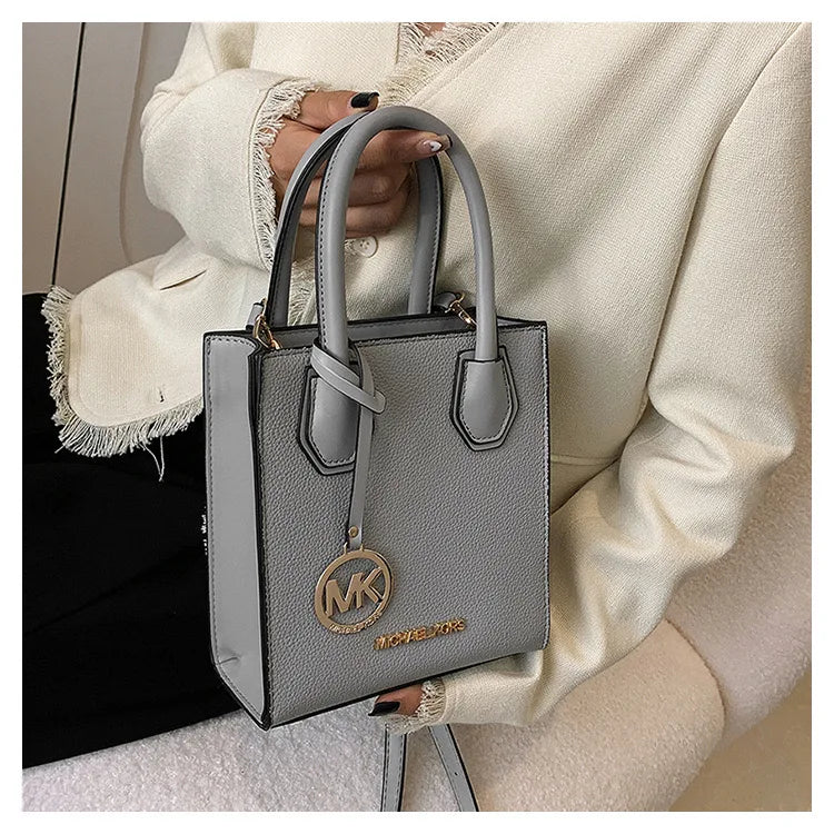 2026 New Michael Kors Women's Fashion One Shoulder Handbag MK Cross Shoulder Vertical Small Square Bag Classic Letter Bag