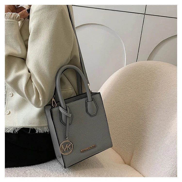 2026 New Michael Kors Women's Fashion One Shoulder Handbag MK Cross Shoulder Vertical Small Square Bag Classic Letter Bag