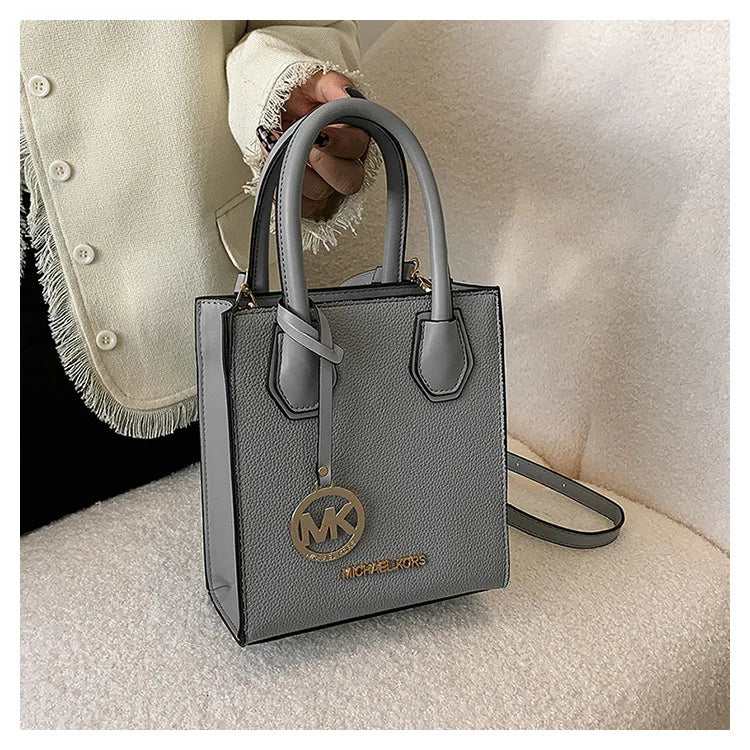 2026 New Michael Kors Women's Fashion One Shoulder Handbag MK Cross Shoulder Vertical Small Square Bag Classic Letter Bag