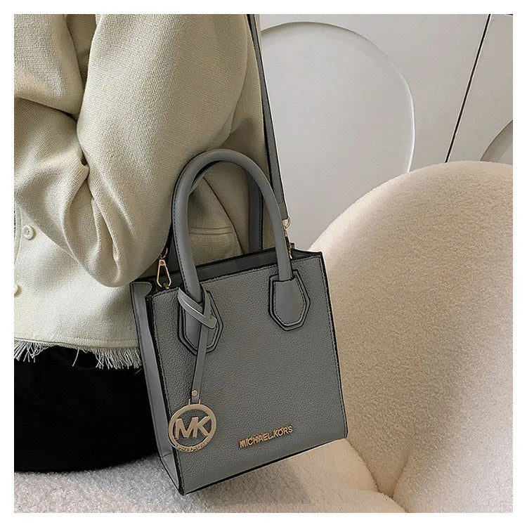 2026 New Michael Kors Women's Fashion One Shoulder Handbag MK Cross Shoulder Vertical Small Square Bag Classic Letter Bag